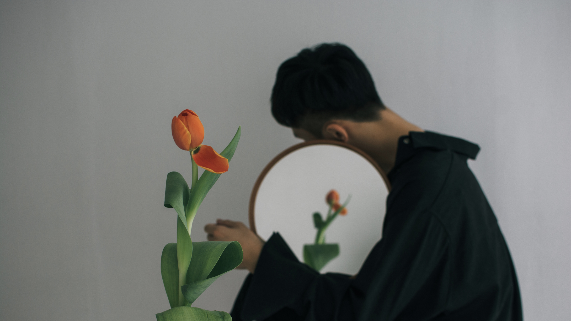 A person looking at their reflection, representing self-examination and the question of whether narcissistic traits shape how we relate to others